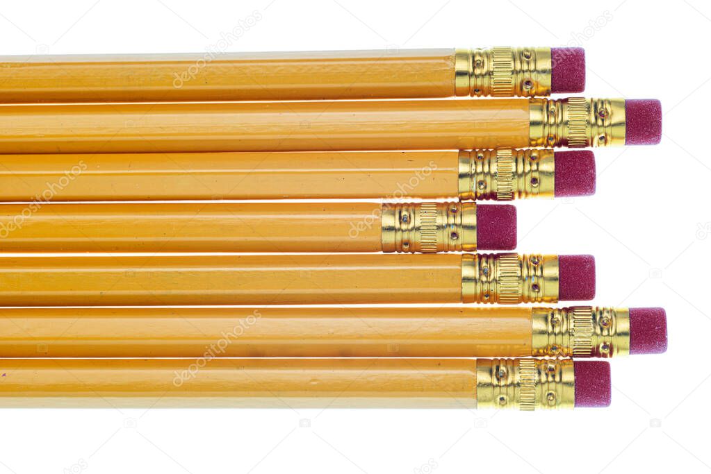 Horizontal close-up shot of the eraser ends of seven pencils laying horizontally left side to right.  They are laying unevenly.  White background.