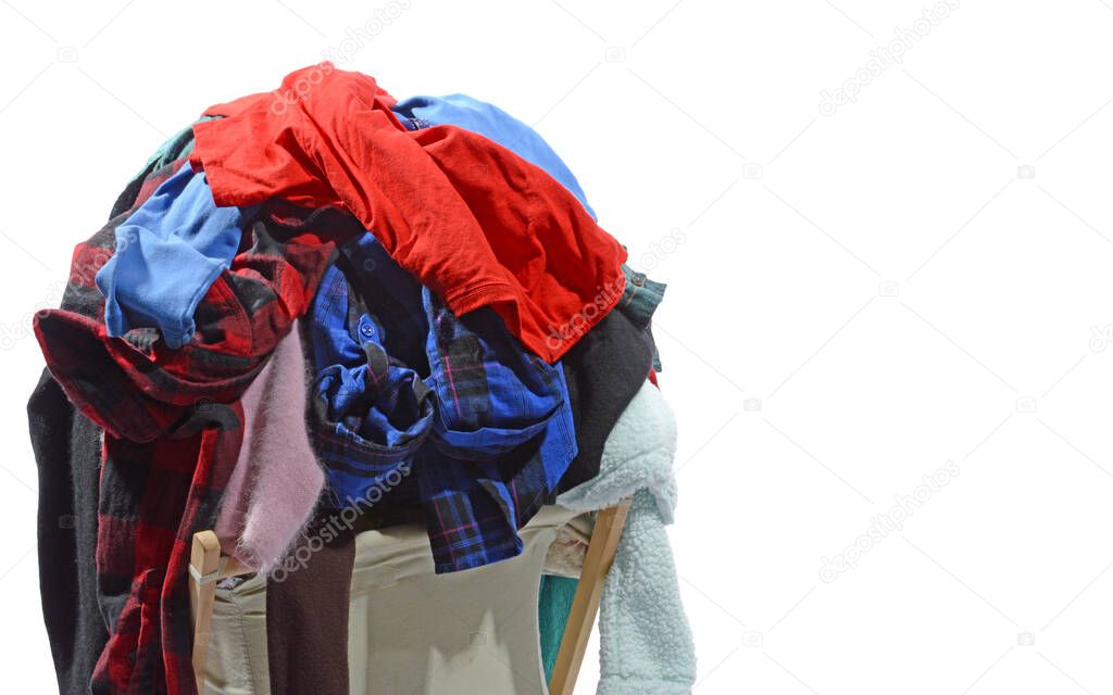 Horizontal shot of an overstuffed laundry hamper isolated on white with copy space of the right side of image.