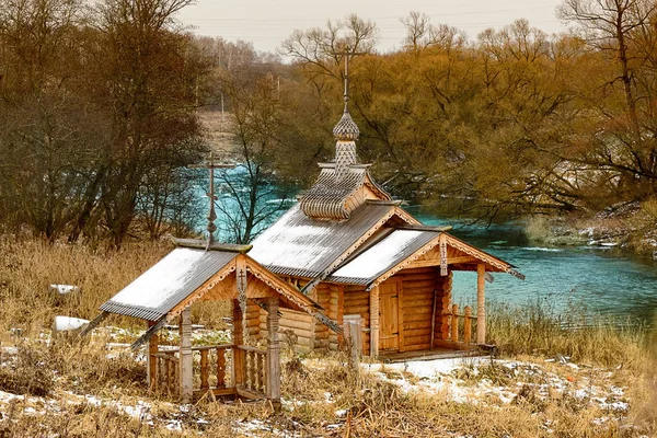 Wooden chapel by the river and spring — Stock Photo, Image