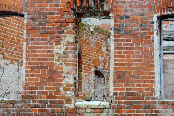 Fragment einer zerstörten Ziegelmauer mit leeren Fenstern — Stockfoto