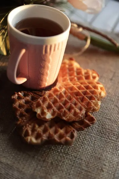 Tea and waffle at sunset — Stock Photo, Image
