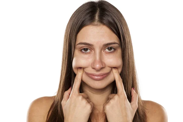 Mulher forçando seu sorriso — Fotografia de Stock