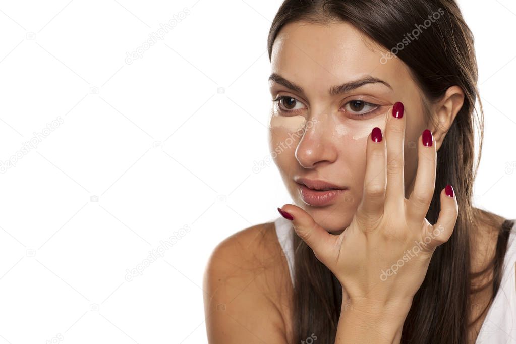 women applying concealer