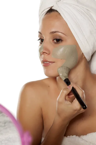 Woman with a mud mask — Stock Photo, Image