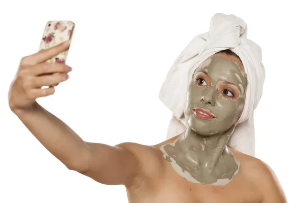 Woman with a mud mask — Stock Photo, Image