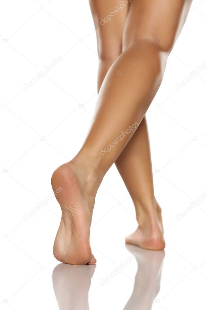  women's legs and feet on white background