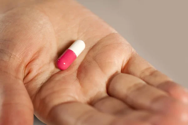 Capsule pill on a hand — Stock Photo, Image