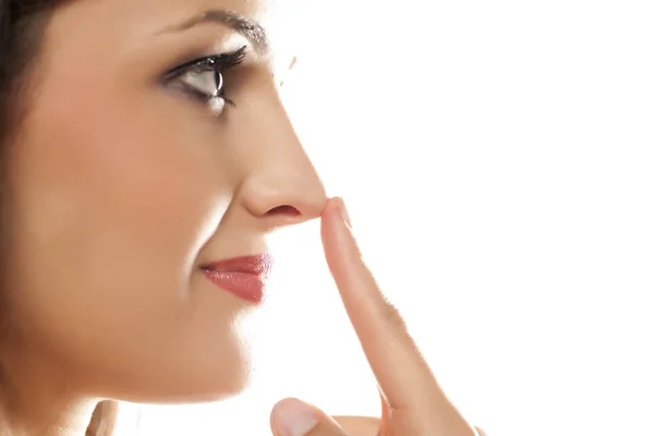 Woman touching her nose — Stock Photo, Image