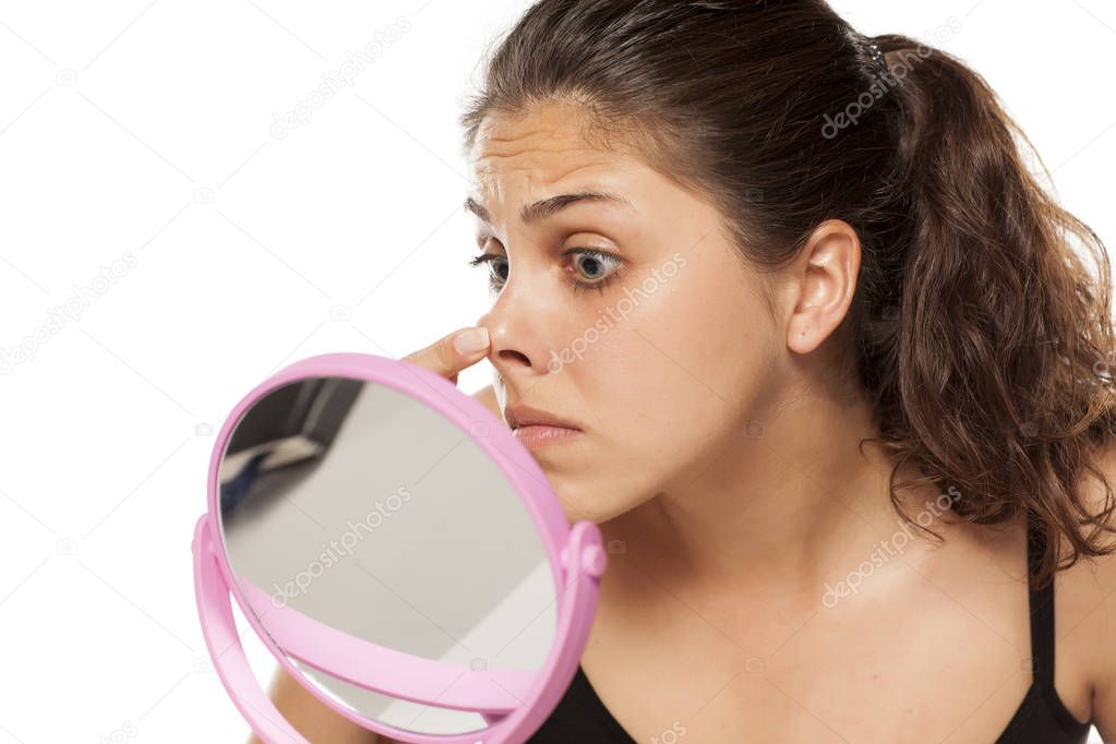 woman checking her nose