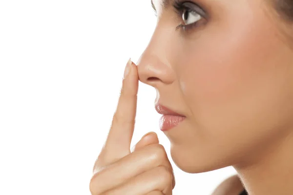 Woman touching her nose — Stock Photo, Image