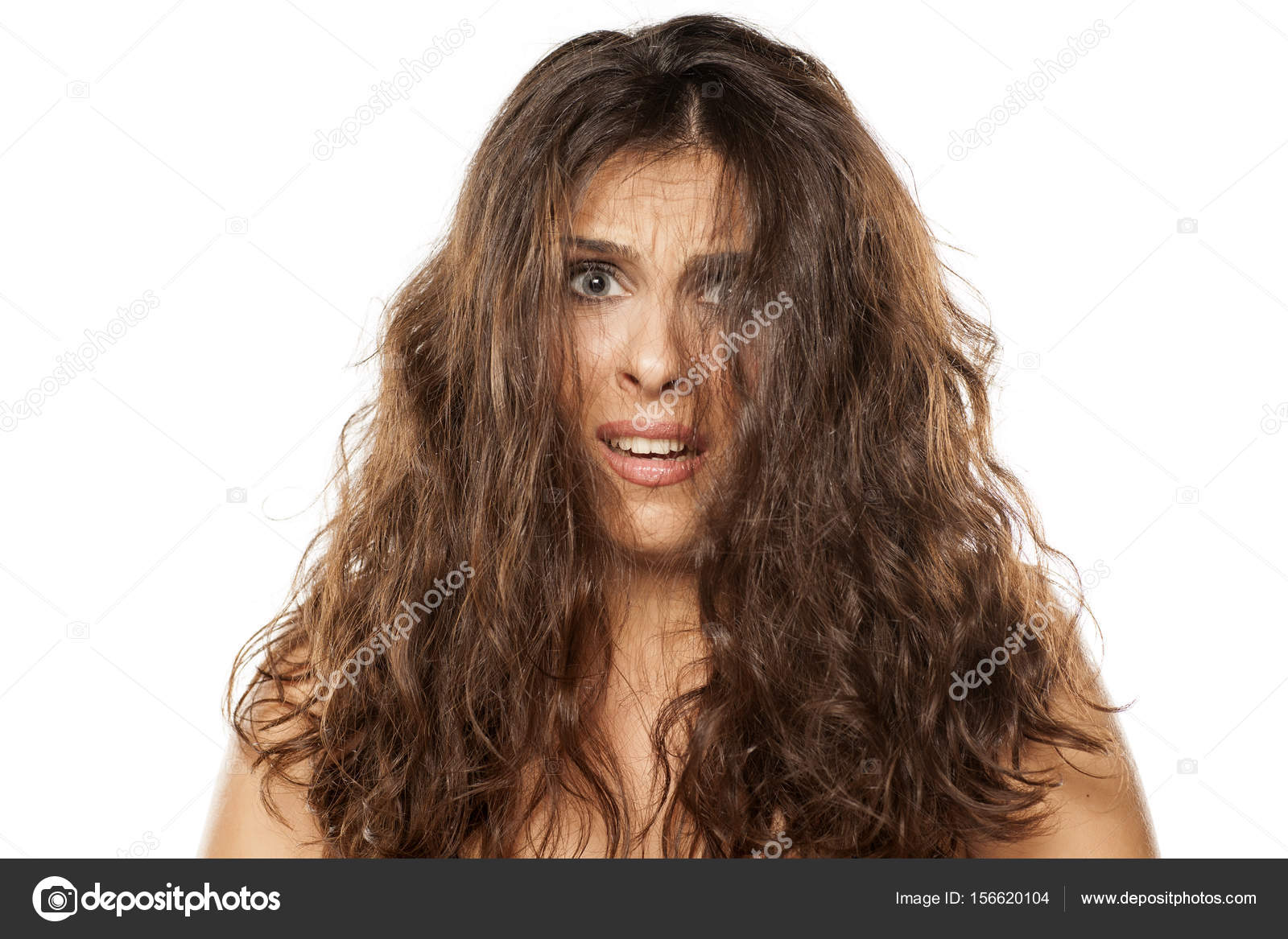 Woman With Big Messy Hair And Wondering Expression Stock Photo