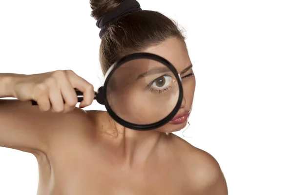 Woman with a magnifying glass — Stock Photo, Image