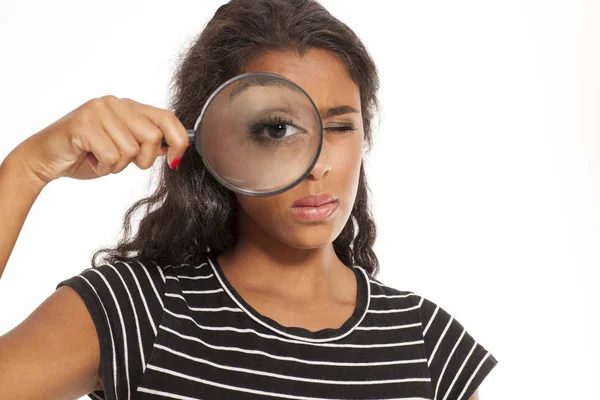 Woman with a magnifying glass — Stock Photo, Image