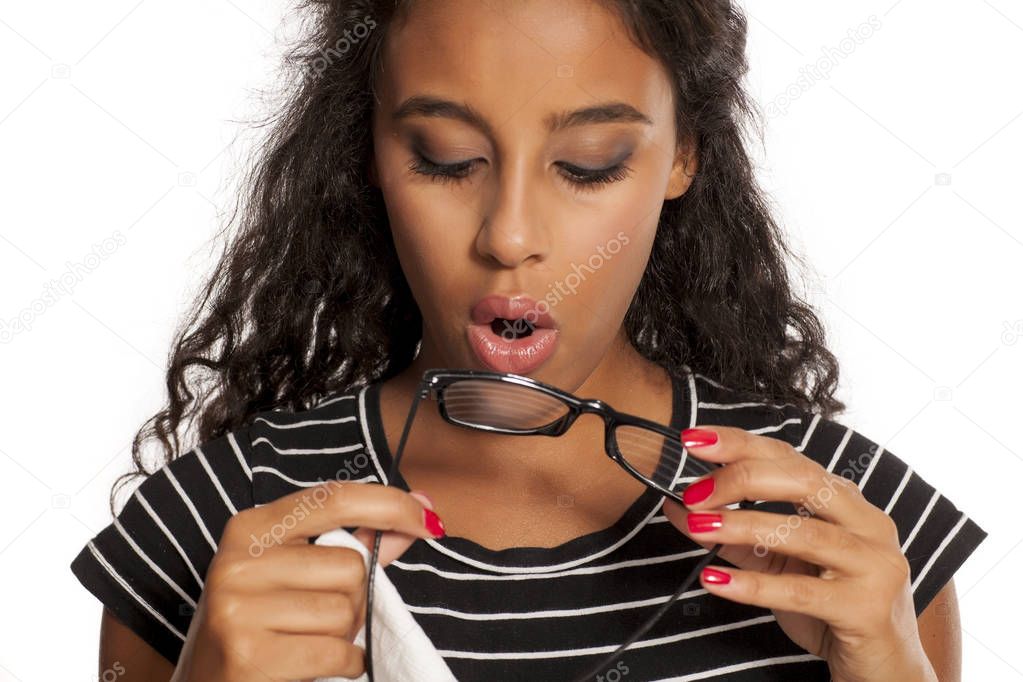 woman cleaning her eyeglasses