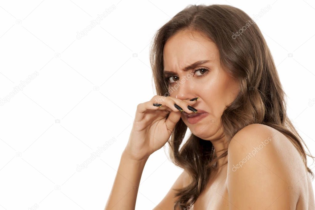 Young disgusted woman on a white background