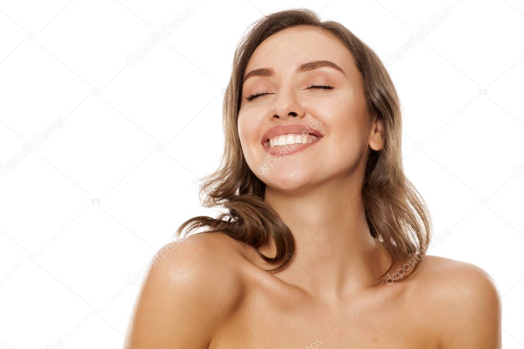 Young beautiful satisfied woman on a white background