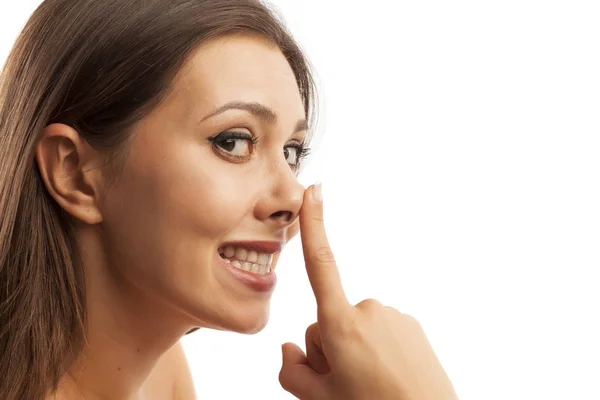 Woman touching her nose — Stock Photo, Image