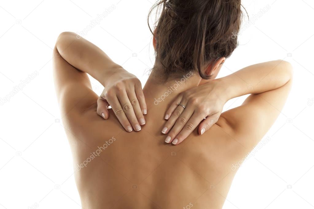 Back view of a woman with pain in her neck and shoulders