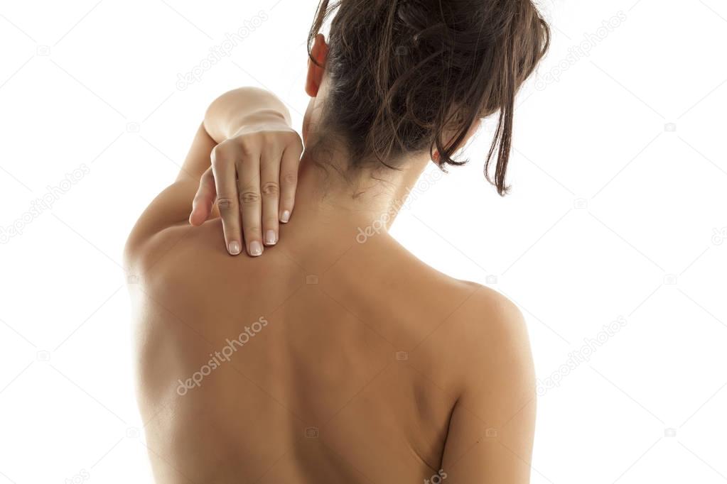 Back view of a woman with pain in her neck and shoulders