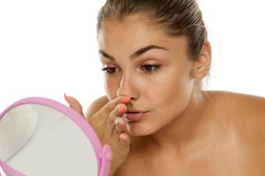 Burnunu bir ayna önünde dokunmadan genç kız