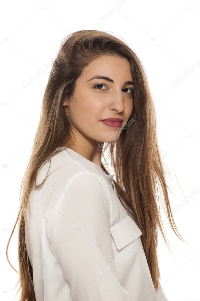 Portrait of a young woman with long hair on a white background