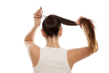 Genç bir kadının saçlarını at kuyruğu içinde bağlama arkadan görünüm 