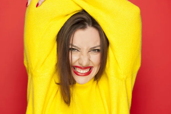 Beautiful Sexy Woman Yellow Blouse Showing Her Teeth Red Background — Stock Photo, Image