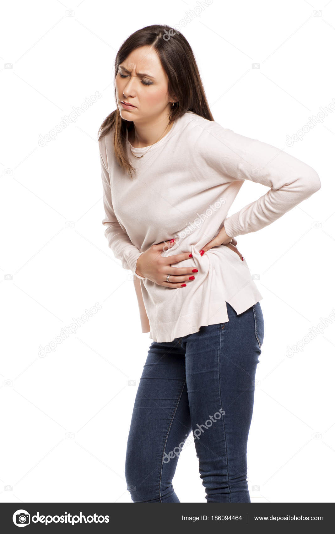 Young woman suffering from flank pain on white background Stock Photo