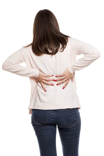 Mujer Joven Con Dolor Espalda Sobre Fondo Blanco —  Fotos de Stock