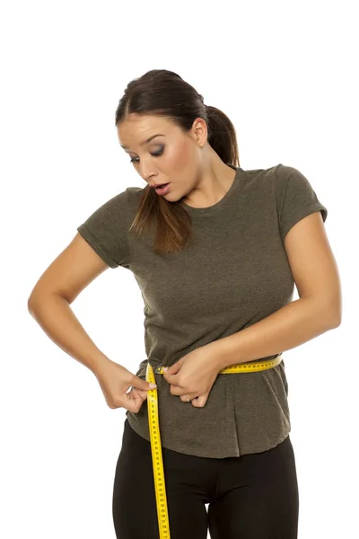 Worried Young Woman Measuring Her Waist White Background Royalty Free Stock Photos