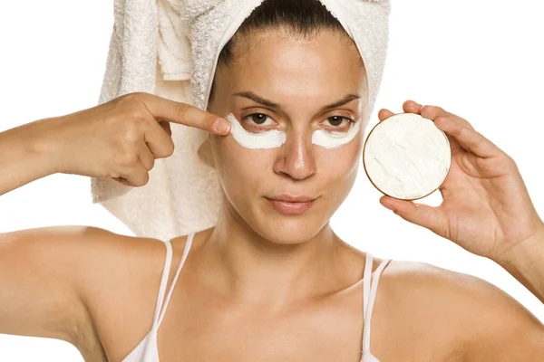Young Woman Applying Face Cream Her Eyes White Background — Stock Photo, Image