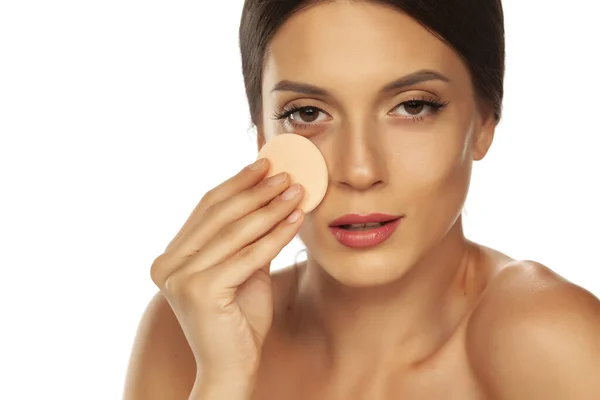 Young beautiful woman claning her face with cotton pad on white — Stock Photo, Image