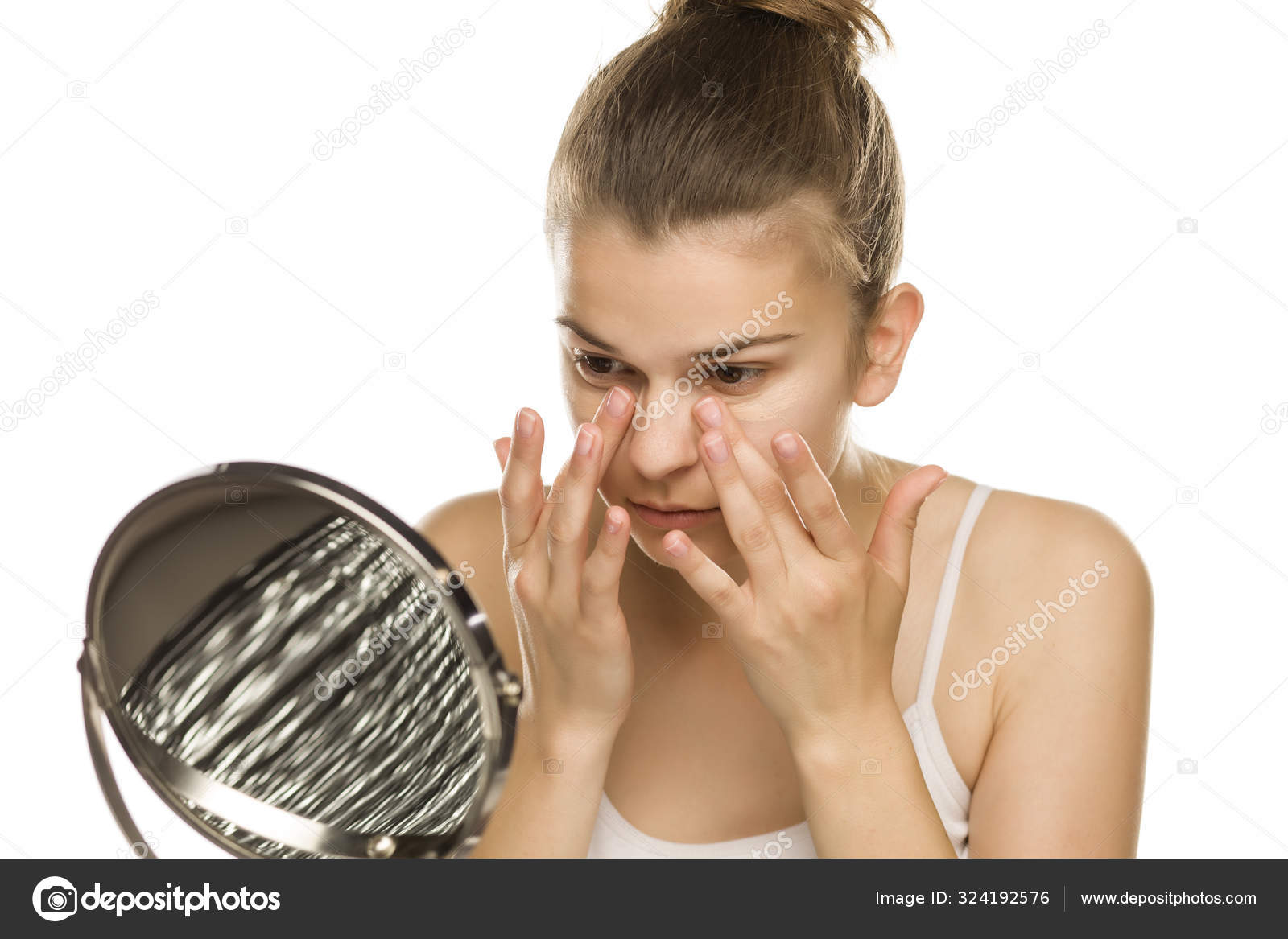 Portrait Young Woman Applying Concealer Her Fingers White Background