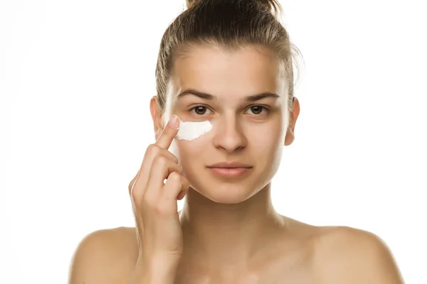 Young Woman Applying Cream Her Eyes White Background — Stock Photo, Image