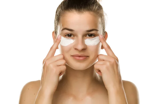 Young Woman Applying Cream Her Eyes White Background — Stock Photo, Image
