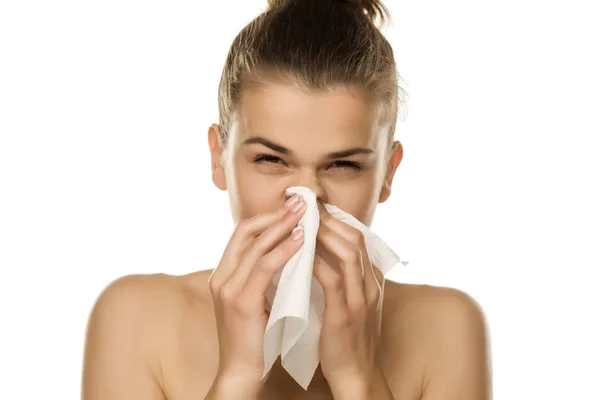 Jonge Vrouw Niezen Een Weefsel Een Witte Achtergrond — Stockfoto