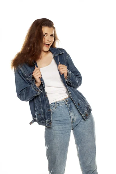 Young beautiful woman in jeans holding imaginary object on her h — Stock Photo, Image