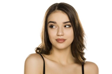 Young woman with makeup, looking aside on white background