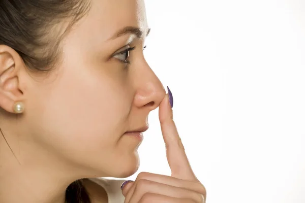 Smiling Woman Touching Her Nose White Background — Stock Photo, Image