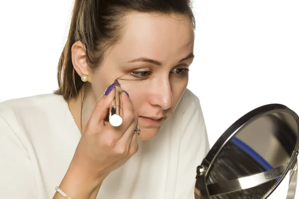 Young Woman Applying Concealer Her Face White Background — Stock Photo, Image