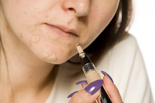 Young Woman Applying Concealer Her Face White Background — Stock Photo, Image