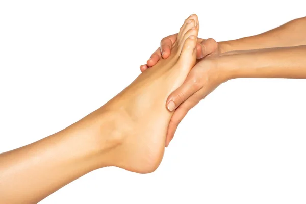 Γυναικείο Χέρι Που Κρατά Θηλυκά Πόδια Λευκό Φόντο — Φωτογραφία Αρχείου