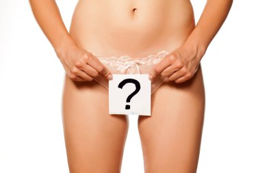 Woman holding a question mark drawn in front of her vagina