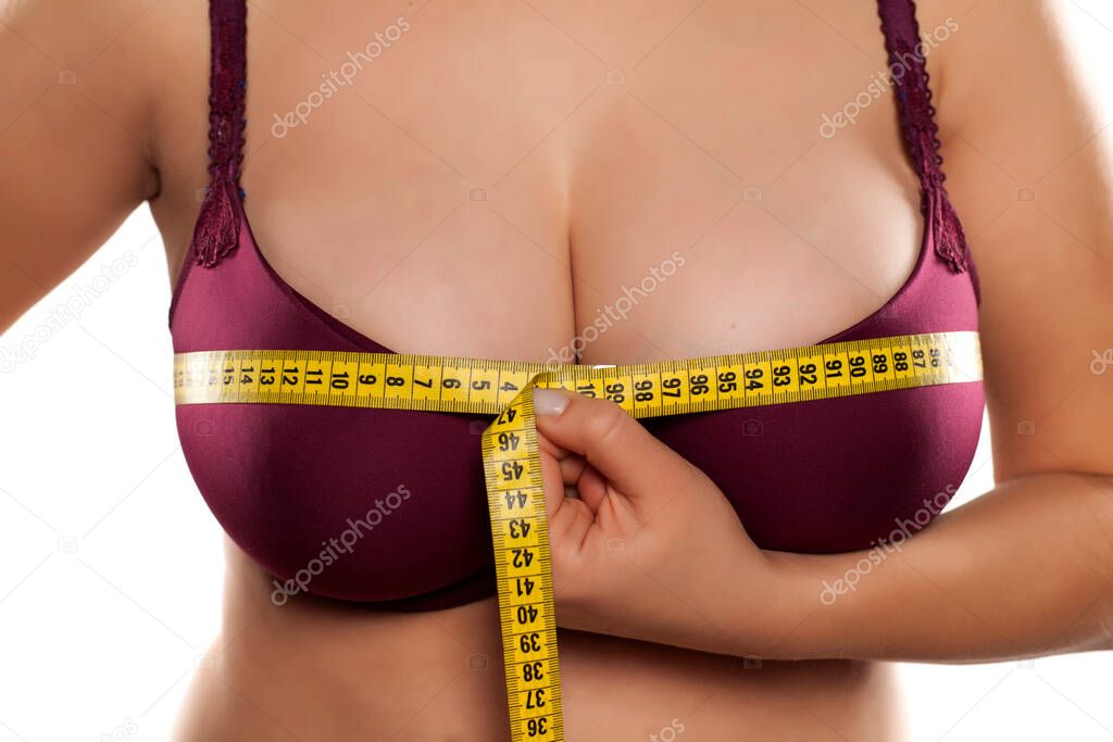 woman measured her huge breast with a measuring tape