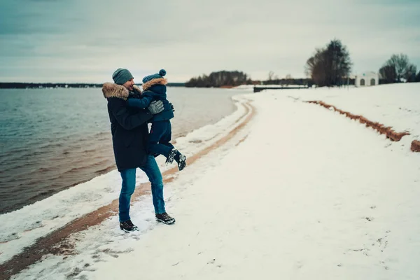 Father Holding Son Hands Standing Beach Lake Winter Time — 스톡 사진