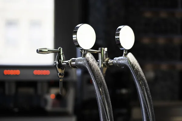 Close-up of shiny beer tap over unfocused background at brewery bar. — Stock Photo, Image