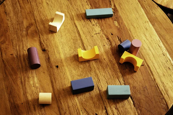 Blocchi di giocattoli, mattoni da costruzione in legno multicolore, mucchio di pezzi di gioco colorati su un tavolo di legno . — Foto Stock