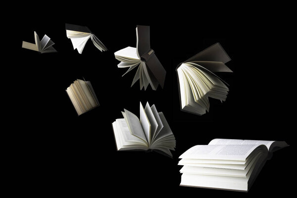 Flying books isolated on black