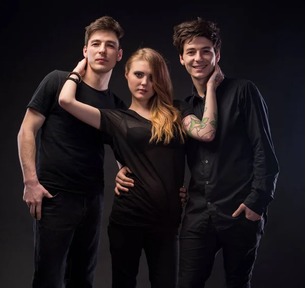 Молода жінка позує з двома молодими чоловіками — стокове фото