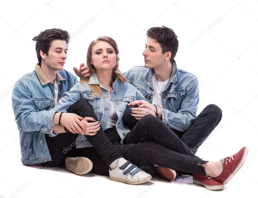 Young woman posing with two young man